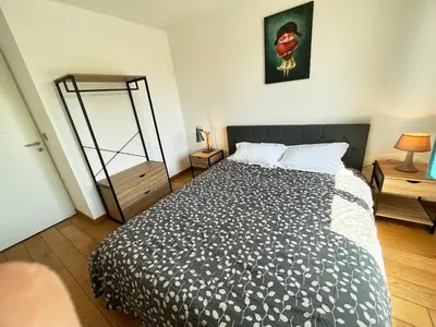 Un ou plusieurs lits dans un hébergement de l'établissement Appartement 84m² avec 2 parkings privatifs