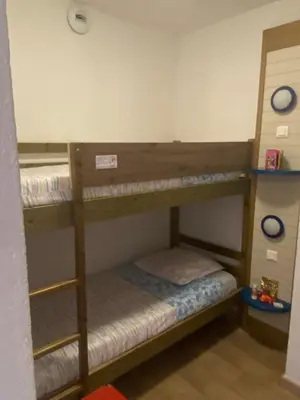 Un ou plusieurs lits dans un hébergement de l'établissement Logement en résidence vacances classe 2 étoiles au bord de mer 4 couchages avec cabine lit superposé et au salon un canapé convertible et piscine à 300 m des transports communs,gare ferroviaire,commerces et plages