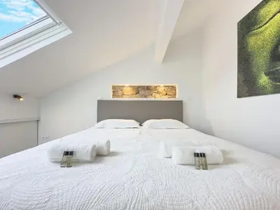 Un ou plusieurs lits dans un hébergement de l'établissement Le Duplex by Winsome Destination