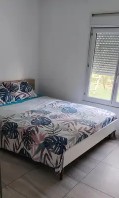 Un ou plusieurs lits dans un hébergement de l'établissement Bas de villa avec piscine et jardin