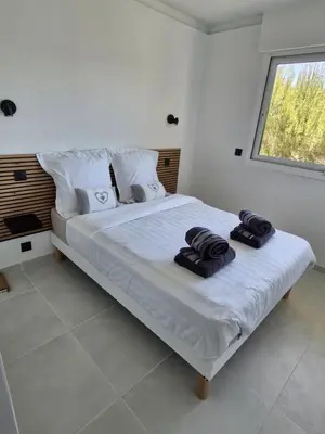 Un ou plusieurs lits dans un hébergement de l'établissement Appartement vu mer et montagnes