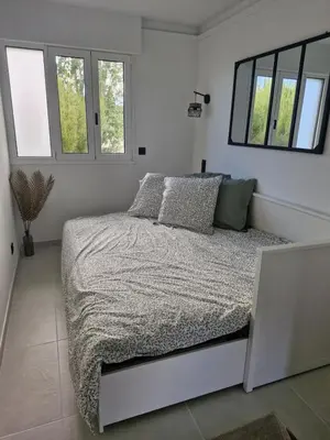 Un ou plusieurs lits dans un hébergement de l'établissement Appartement vu mer et montagnes