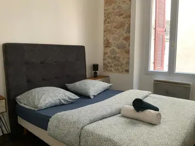 Un ou plusieurs lits dans un hébergement de l'établissement appartement palmiers 2 pieces