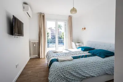 Un ou plusieurs lits dans un hébergement de l'établissement Appart 3 chambres - Les Lys