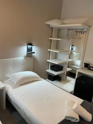 Un ou plusieurs lits dans un hébergement de l'établissement Hôtel Anna Livia