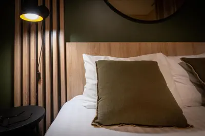 Un ou plusieurs lits dans un hébergement de l'établissement Nemea Appart Hotel Green Side Biot Sophia Antipolis