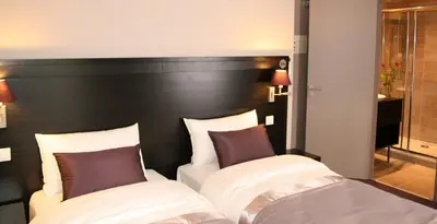Un ou plusieurs lits dans un hébergement de l'établissement La Place Boutique Hotel