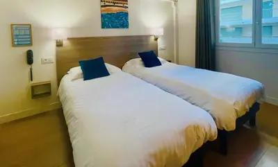 Un ou plusieurs lits dans un hébergement de l'établissement Hotel Courbet