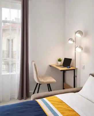 Un ou plusieurs lits dans un hébergement de l'établissement Cannes centre apartment with a balcony